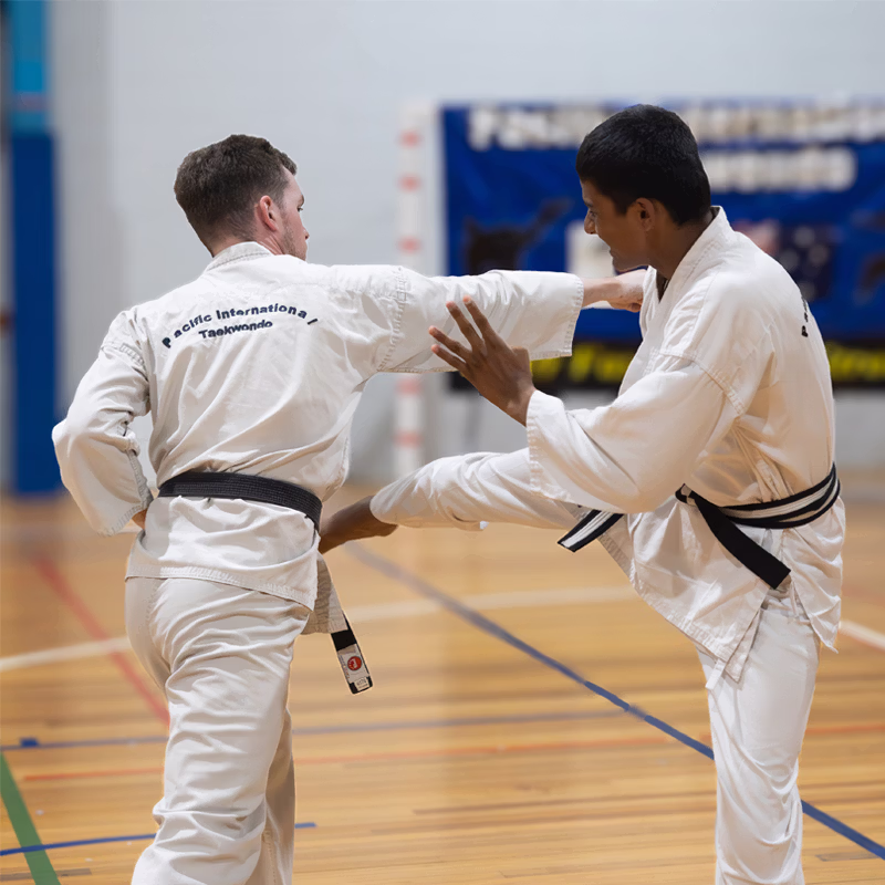 ALBANY CREEK instructor spars with junior black belt