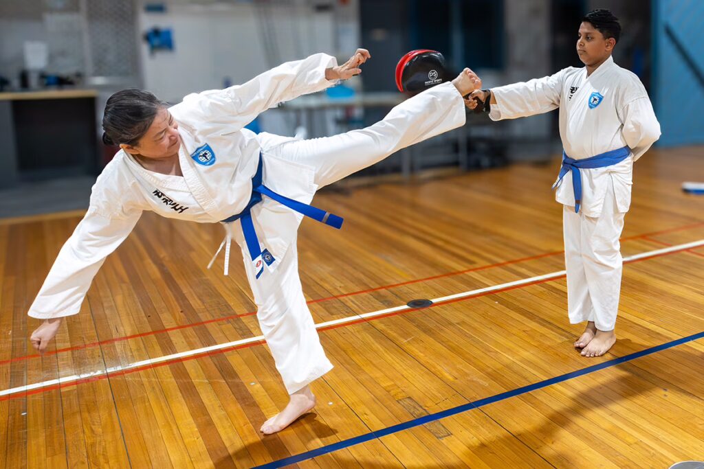 ALBANY CREEK older lady horizontal kick at pad