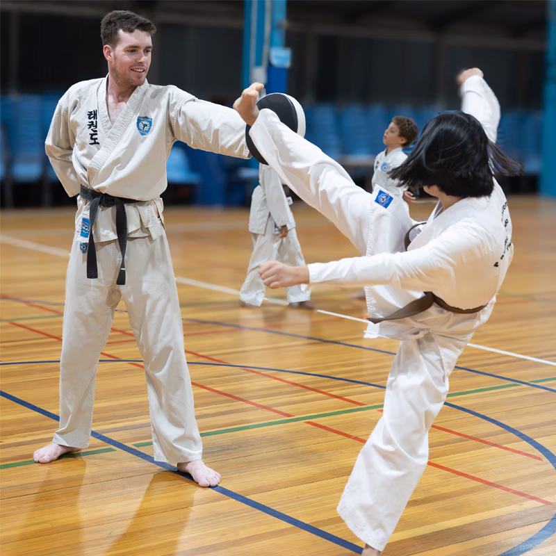 ALBANY CREEK teen girl horizontal kick at pad